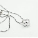 Catenina con punto luce montatura a croce con diamante