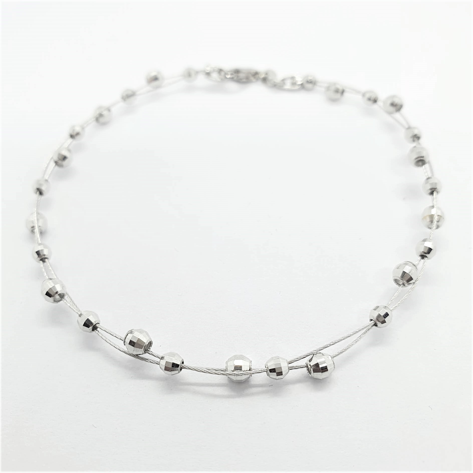 288145808_746198423245769_7565543441836671392_n.jpg Bracciale a due fili con palline - immagine 1